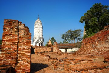 Travel Thailand - Pagoda in Wat Phutthaisawan on blue sky background, Ayutthaya Historical Park. The brick pagoda at old ayutthaya temple ruins. Space for text in template.