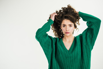 Parisian girl in winter clothes. Retro girl with stylish makeup and hair in paris. Fashion look and beauty concept. girl with curly hair at hairdresser at white wall. Fashion woman in green sweater