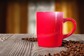 red mug on a wooden surface