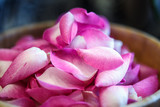 Fototapeta Storczyk - Close-up macro photo of rose petals in a wooden bowl