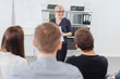 © contrastwerkstatt - Businesswoman giving a presentation to colleagues