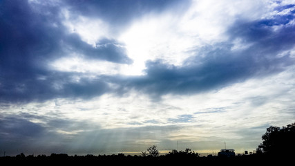 Wall Mural - sun and sky with clouds background, Landscape rays of the sun through white clouds against a blue sky, bautiful sunset. Sun rays make their way through the clouds during the sunset against