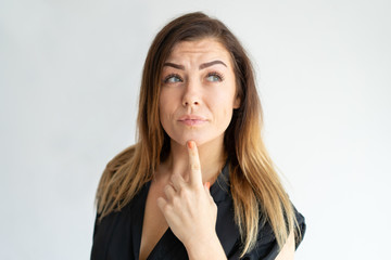 Poster - Pensive Caucasian lady planning, thinking Long haired young woman leaning chin on index finger and looking away. Planning or decision making concept