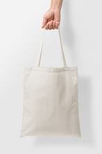 Mockup Of Female Hand Holding A Blank Tote Canvas Bag On Light Grey Background. High Resolution. 
