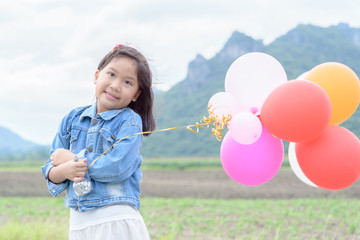 Wall Mural - cute asian girl smile and holding balloon.