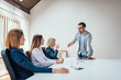 © bnenin - Handsome businessman presenting new business strategy to partners in the office.