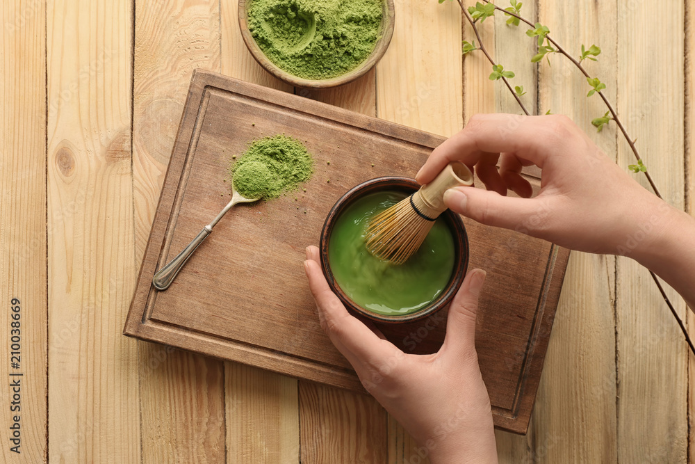Woman preparing matcha tea, closeup