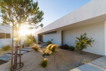 Modern house with garden swimming pool and wooden deck