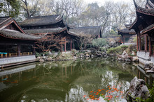 Traditional Chinese Architecture And Tea House Reflecting On A Pond With Red Carps (translation: Tea House)