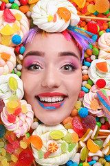 Sticker - Face of beautiful young woman with creative makeup surrounded by different sweets