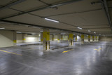 Fototapeta  - Empty underground parking. Even rows with bright markings.