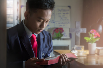 Man holding and reading holy Bible at home, christian concept.