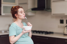 Beautiful Pregnant Woman Eating Cereals 
