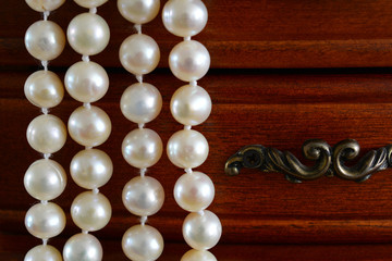 Casket with a necklace of river pearls. Wooden box, сasket for women's jewelry in the form of a chest of drawers.