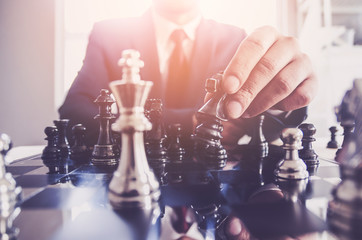 Detail of a hand making the first move in a chess game, moving the pawn one field forward. Selective focus