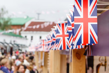 Shallow Focus Image Of A Union Jack Flack On A Row On Flag Bunting, Above A Market Stall.