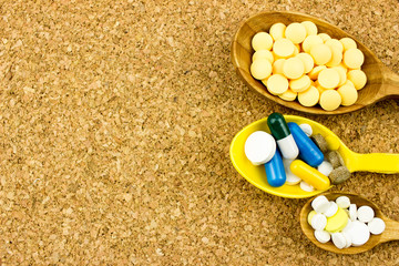 Wall Mural - Capsules and tablets on spoon. Medicine pharmaceutical theme. Free space for text