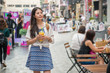 © PR Image Factory - woman holding a cup of mango juice and shopping
