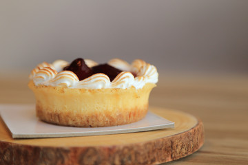 Strawberry tart pie on wooden plate.