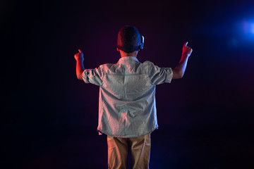 So involved. Determined dark-haired boy wearing a VR headset and touching imaginary images