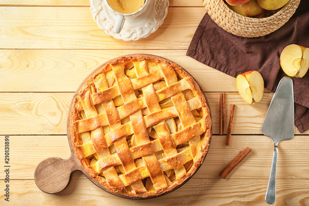 Composition with delicious apple pie on wooden background