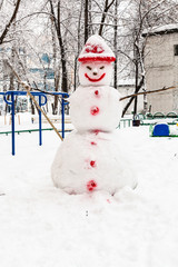 Sticker - snowman at public urban yard in winter day