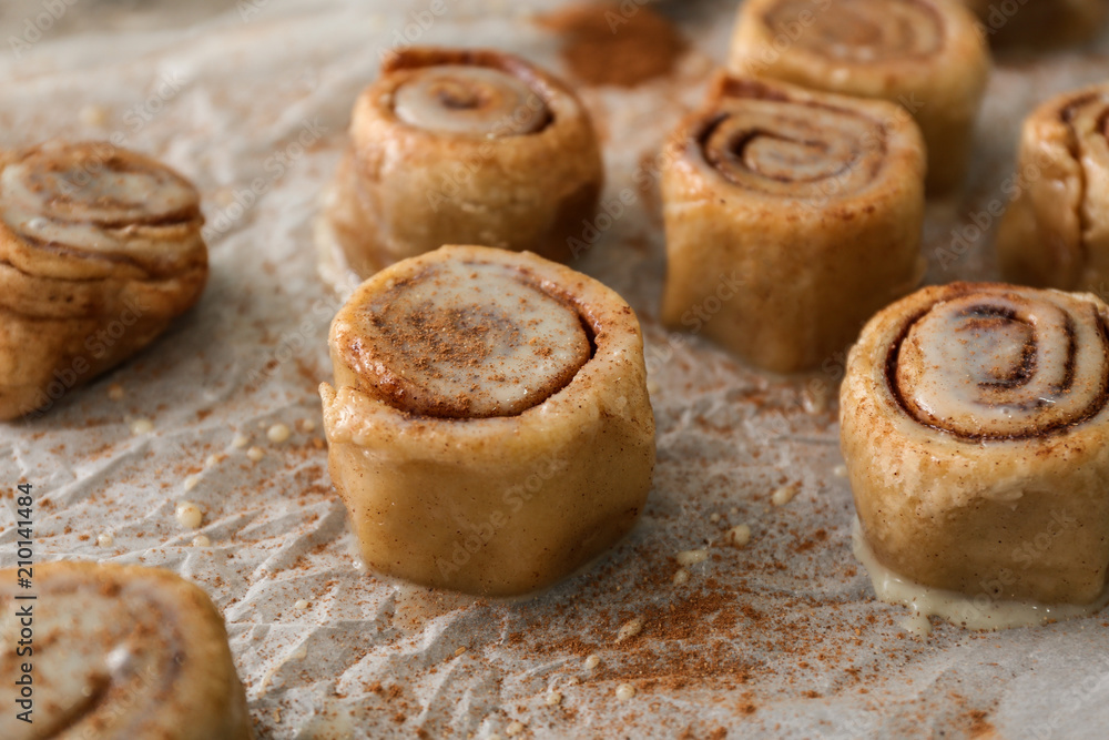 Tasty cinnamon buns on table, closeup