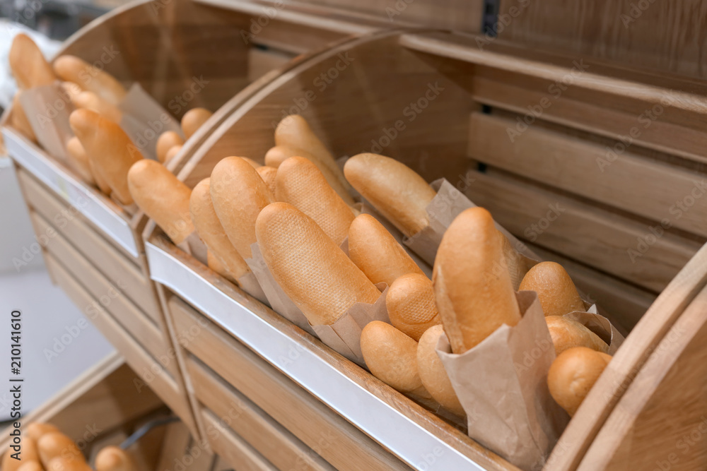 Tasty fresh baguettes on display in bakery
