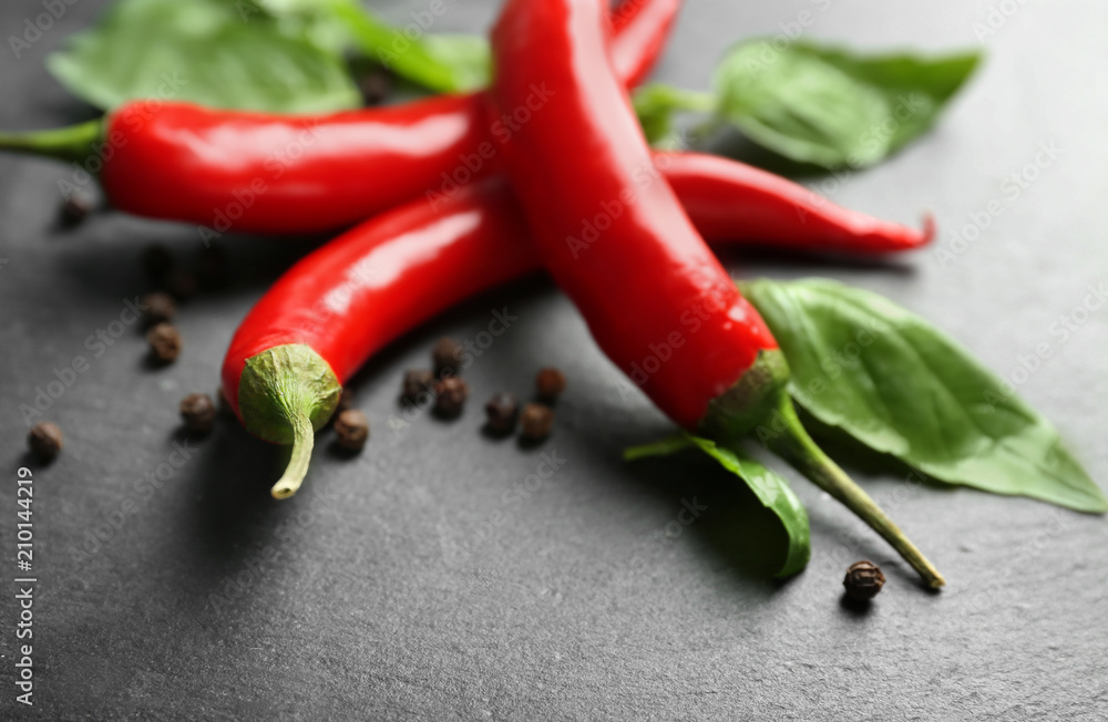 Fresh chili peppers on dark background, closeup