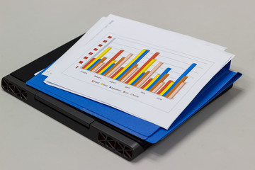 a paper sheet chart and laptop for preparation for business on the table in the meeting room, concept business office expenses.