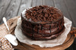 © Pixel-Shot - Board with delicious chocolate cake on wooden table