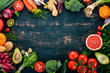 Healthy food. Vegetables and fruits. On a black wooden background. Top view. Copy space.