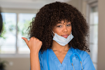 Poster - African american woman medical professional pointing with hand and finger up with happy face smiling