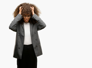 Poster - African american business woman wearing glasses suffering from headache desperate and stressed because pain and migraine. Hands on head.