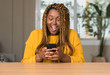 © Krakenimages.com - African american woman using smartphone scared in shock with a surprise face, afraid and excited with fear expression