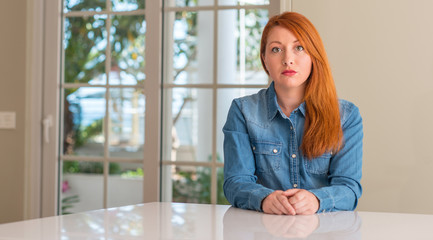 Sticker - Redhead woman at home with a confident expression on smart face thinking serious