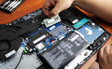 The technician hold the screwdriver for repairing the computer, the concept of computer hardware, repairing, upgrade and technology