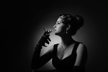 Dramatic Portrait Of A Beautiful Woman With Glass Of Martini .