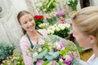 © auremar - Florist giving lady a flower arrangement
