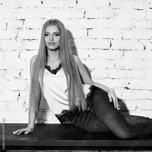 Young Beautiful Woman With Long Straight Blonde Hair In Blue Jeans