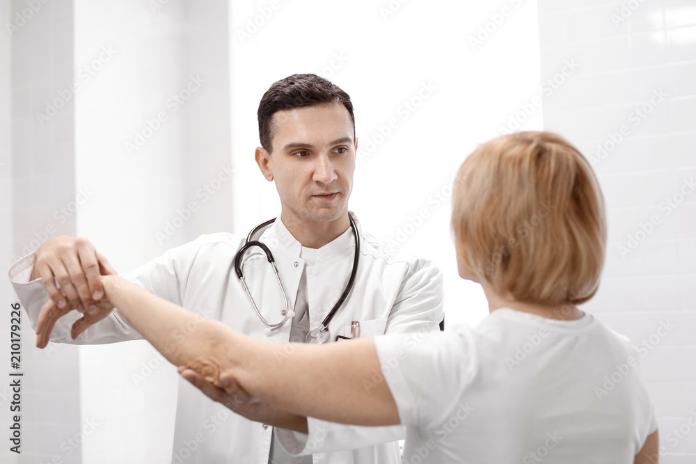 Orthopedist examining patient in hospital