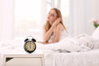 © Pixel-Shot - Alarm clock on table in bedroom of beautiful woman. Morning time