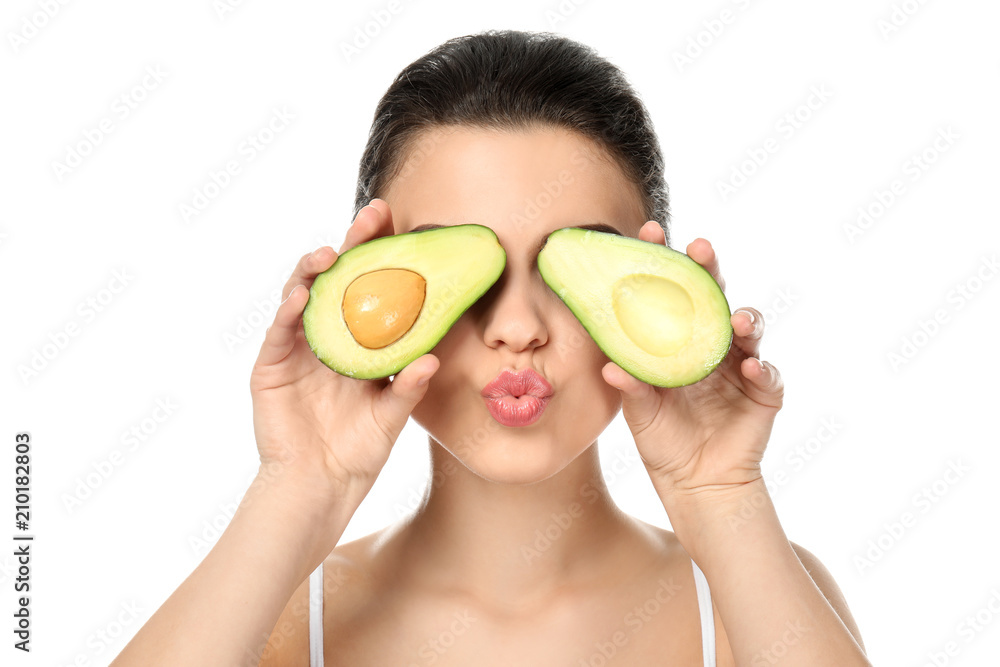 Funny young woman with avocado on white background