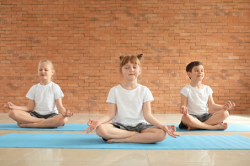 Wall Mural - Little children practicing yoga indoors