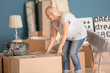 © Pixel-Shot - Mature woman with moving boxes and belongings at new home