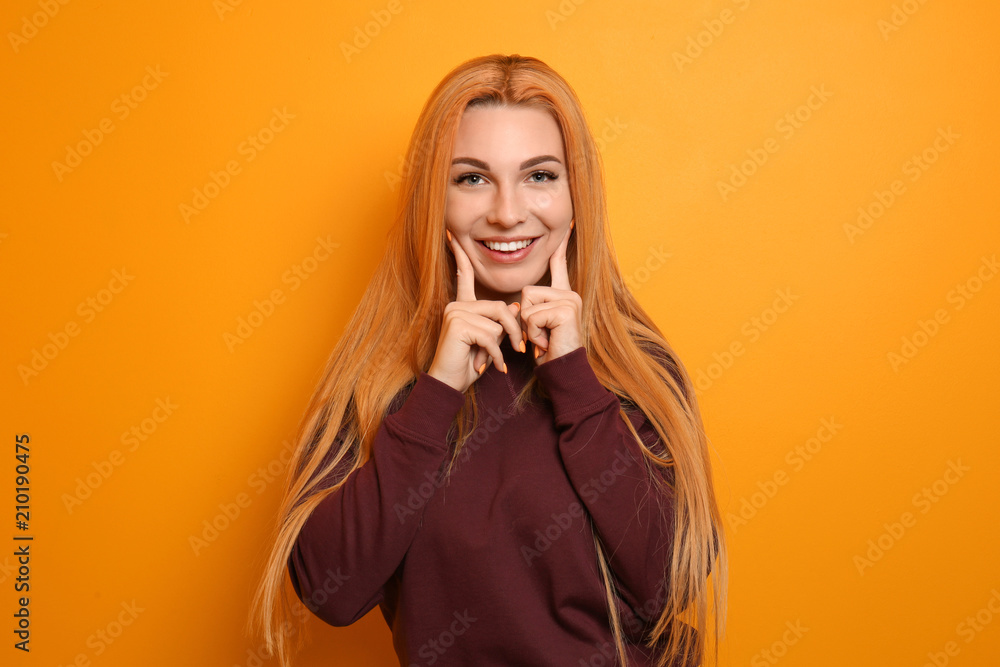 Beautiful young woman on color background