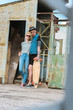 © LIGHTFIELD STUDIOS - boyfriend with tattoos and stylish girlfriend posing with longboard and looking away