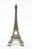 Fototapeta Boho - miniature model of a golden Eiffel tower on a white background (mock-up)