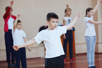 Primary school children a sport lesson indoors