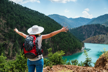 Wall Mural - Woman traveler with backpack enjoying view